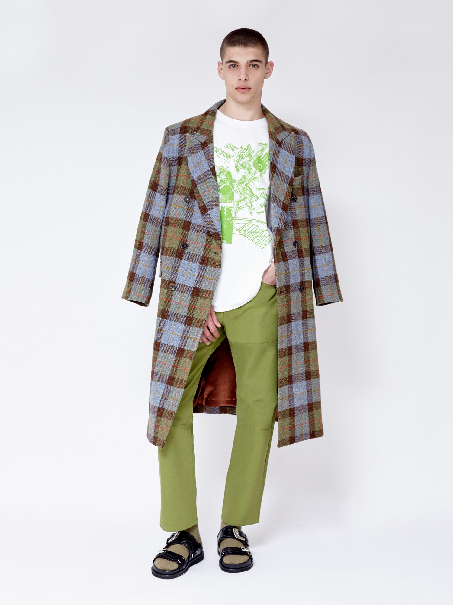 Casually styled check wool overcoat, styled with green straight leg trouser. Helps to pull out matching green in the coat.